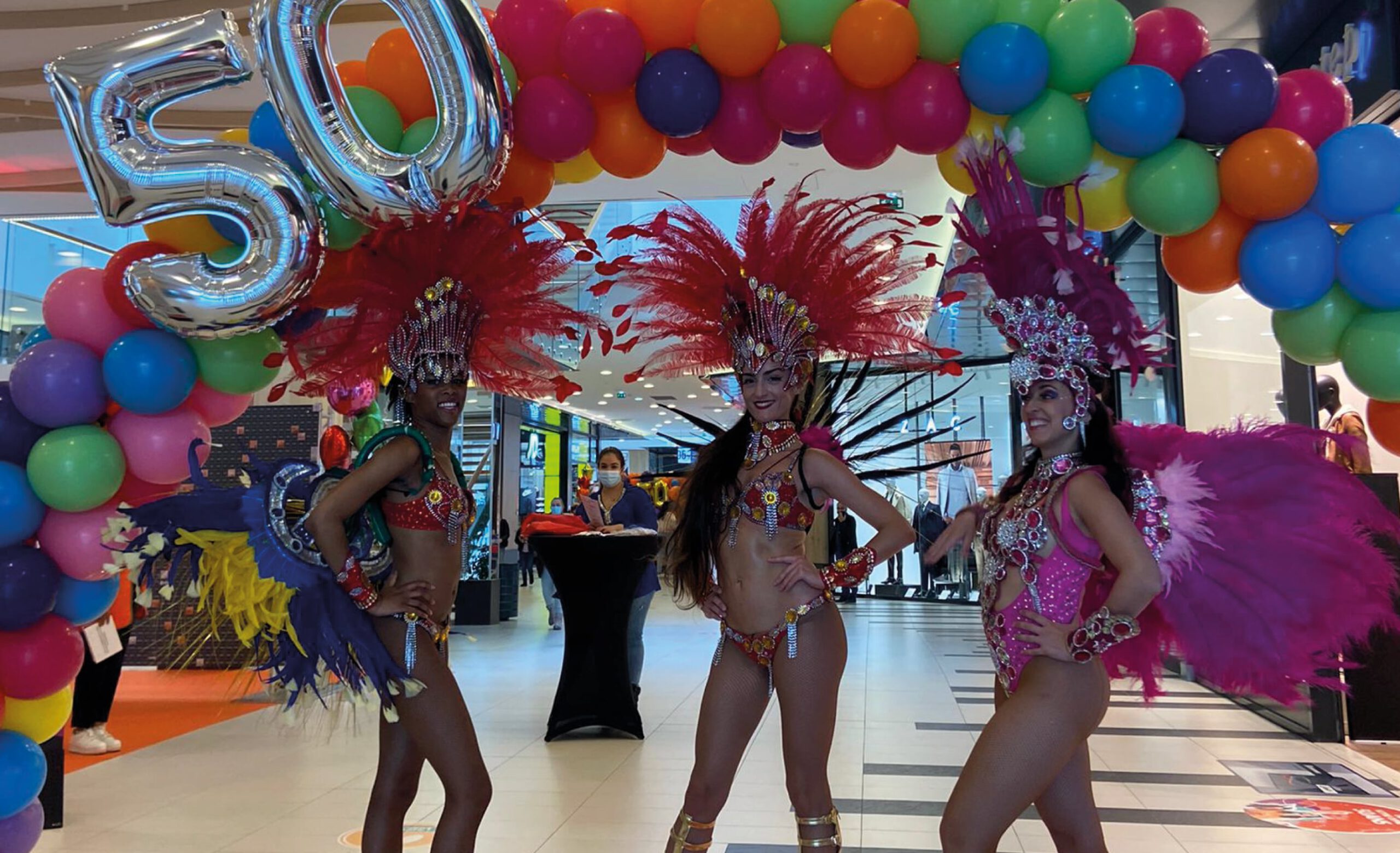 Danseuses brésiliennes devant l'arche d'anniversaire du centre commercial
